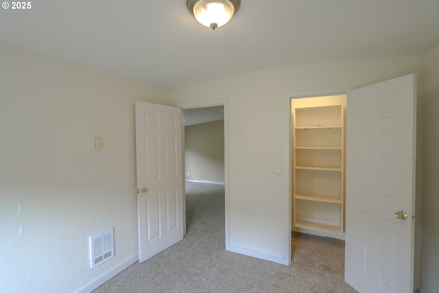 58798 Fairview Rd, Coquille, OR 97423 - unfurnished bedroom featuring a walk in closet, carpet floors, baseboards, and a closet