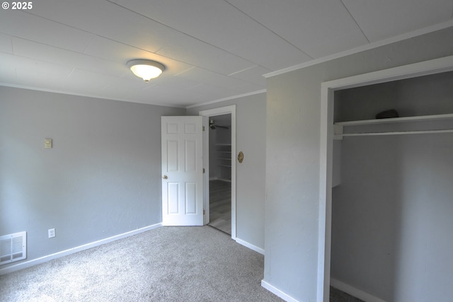 58798 Fairview Rd, Coquille, OR 97423 - unfurnished bedroom featuring a closet, baseboards, carpet flooring, a walk in closet, and ornamental molding