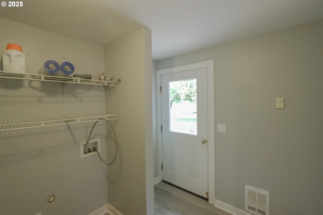 58798 Fairview Rd, Coquille, OR 97423 - washroom featuring baseboards, wood finished floors, and washer hookup