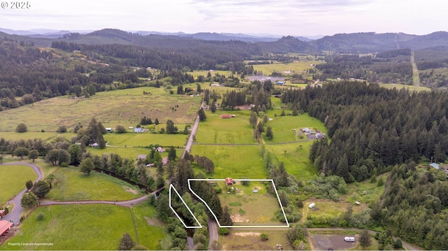 58798 Fairview Rd, Coquille, OR 97423 - overview of rural landscape featuring property parcel outlined, a mountainous background, and a heavily wooded area