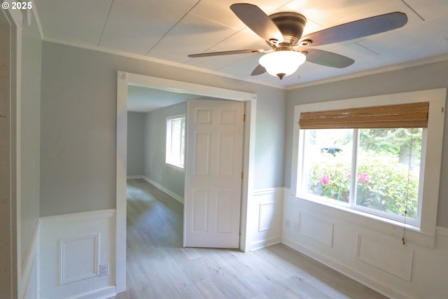 58798 Fairview Rd, Coquille, OR 97423 - empty room with light wood-type flooring, wainscoting, crown molding, and ceiling fan