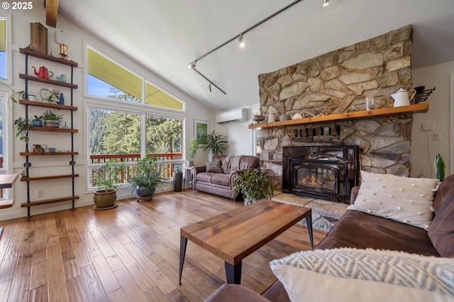 49867 Hills Creek Rd, Oakridge, OR 97463 - living room with track lighting, hardwood / wood-style floors, a wall mounted AC, and vaulted ceiling