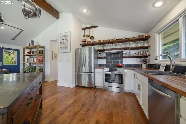 49867 Hills Creek Rd, Oakridge, OR 97463 - kitchen with open shelves, a sink, lofted ceiling with beams, stainless steel appliances, and butcher block countertops