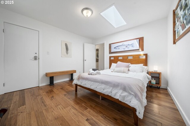 49867 Hills Creek Rd, Oakridge, OR 97463 - bedroom featuring a skylight, hardwood / wood-style floors, and baseboards