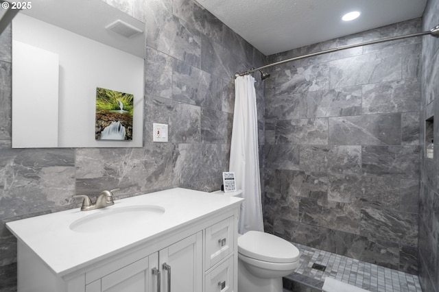 49867 Hills Creek Rd, Oakridge, OR 97463 - bathroom with a tile shower, tile walls, toilet, vanity, and visible vents