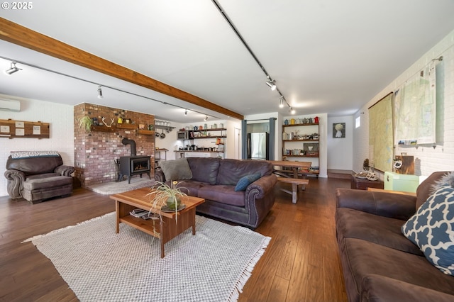 49867 Hills Creek Rd, Oakridge, OR 97463 - living room featuring a wood stove, wood finished floors, and rail lighting