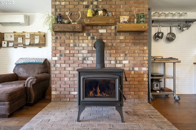 49867 Hills Creek Rd, Oakridge, OR 97463 - details with a wall mounted air conditioner, a wood stove, and wood finished floors