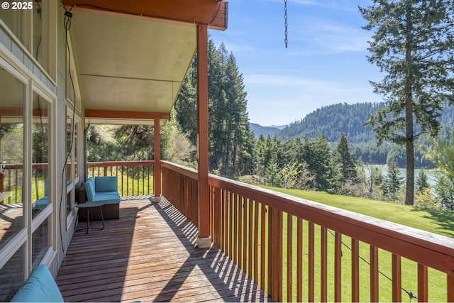 49867 Hills Creek Rd, Oakridge, OR 97463 - wooden terrace featuring a mountain view, a lawn, and a view of trees