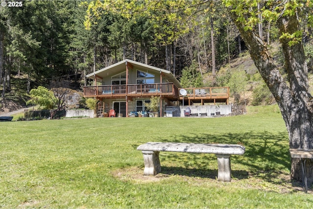 49867 Hills Creek Rd, Oakridge, OR 97463 - rear view of house with a wooden deck, a forest view, and a yard