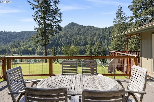 49867 Hills Creek Rd, Oakridge, OR 97463 - deck with a lawn, outdoor dining space, a mountain view, and a view of trees