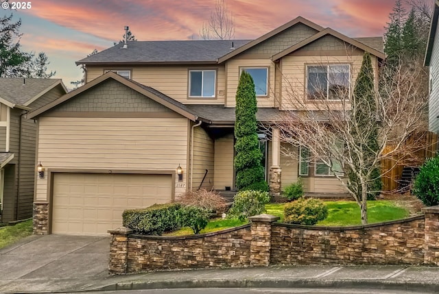 craftsman-style home featuring a garage, roof with shingles, and driveway