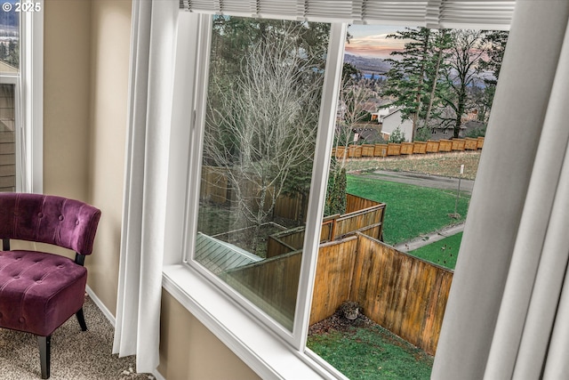 doorway to outside with carpet floors and baseboards