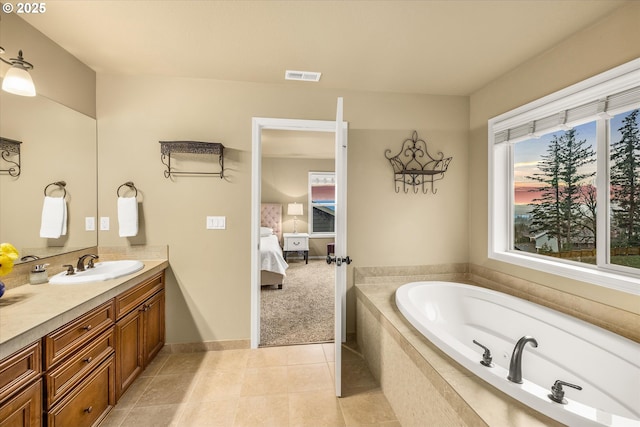 ensuite bathroom featuring visible vents, ensuite bathroom, tile patterned flooring, vanity, and a bath