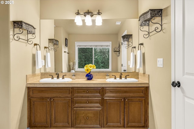 full bathroom with a sink and double vanity