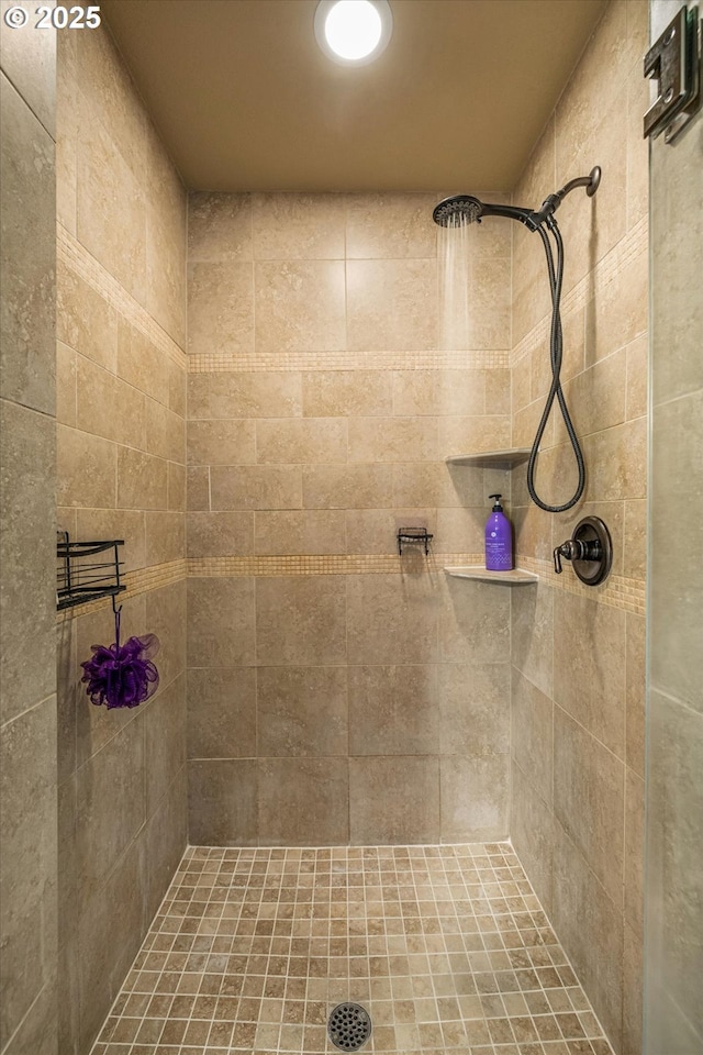 full bath with a tile shower