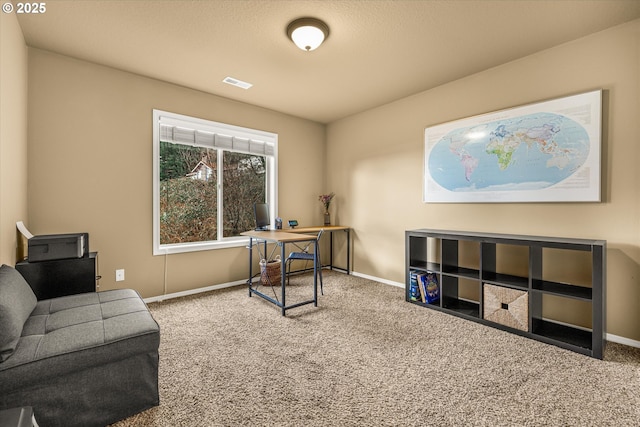 carpeted office with baseboards and visible vents