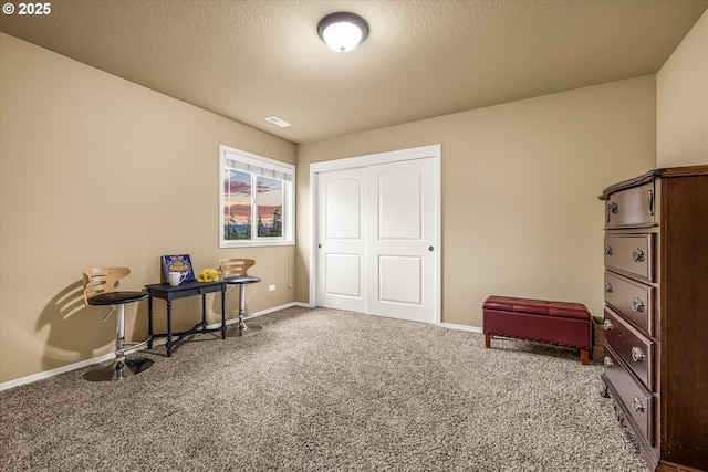 miscellaneous room with carpet, visible vents, a textured ceiling, and baseboards