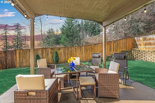 view of patio with outdoor dining area and a fenced backyard