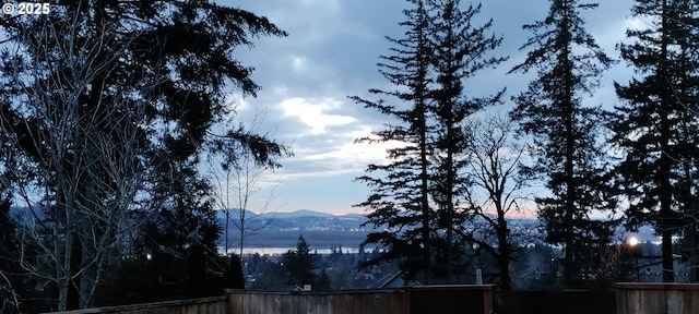 view of water feature featuring a mountain view and fence