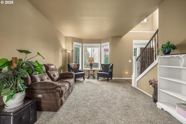 living area with a textured ceiling, stairway, carpet flooring, and baseboards