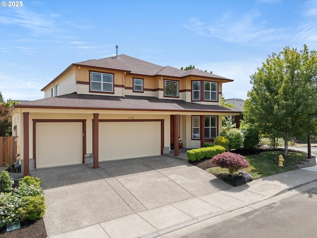 12988 NW Tigon Ln, Portland, OR 97229 - prairie-style home with driveway, a garage, roof with shingles, and covered porch