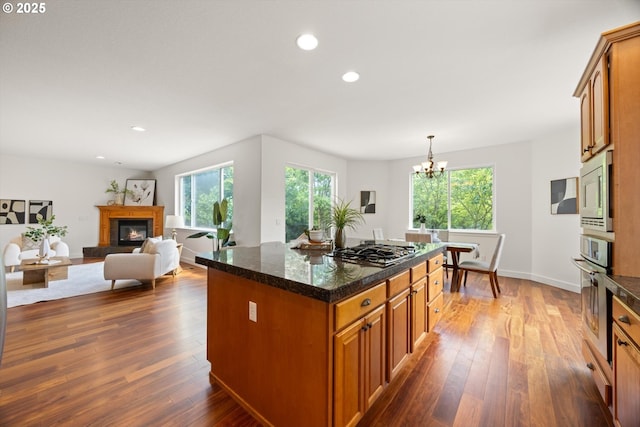 12988 NW Tigon Ln, Portland, OR 97229 - kitchen with stainless steel appliances, plenty of natural light, brown cabinetry, and recessed lighting