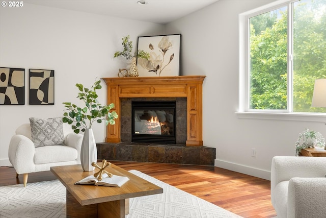 12988 NW Tigon Ln, Portland, OR 97229 - living area with plenty of natural light, wood finished floors, a tile fireplace, and recessed lighting