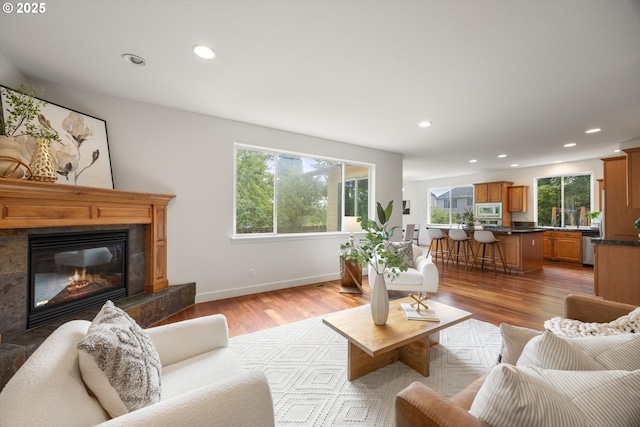 12988 NW Tigon Ln, Portland, OR 97229 - living room featuring plenty of natural light, recessed lighting, a fireplace, and light wood finished floors