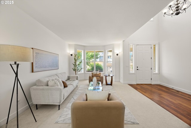 12988 NW Tigon Ln, Portland, OR 97229 - living room with carpet, wood finished floors, and a chandelier