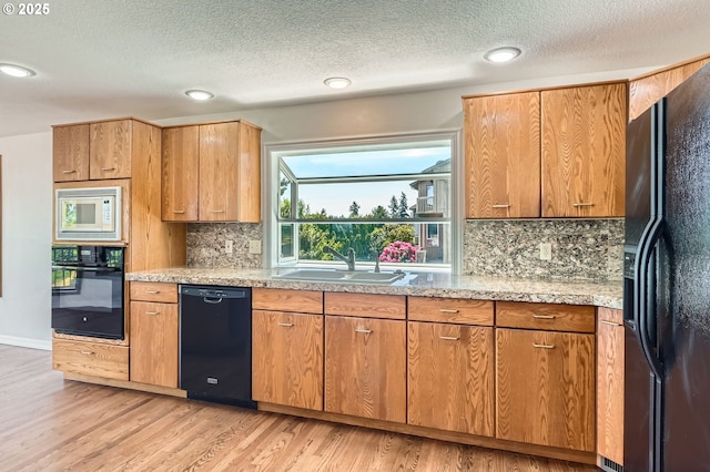 15911 NE 29th Ave, Ridgefield, WA 98642 - kitchen with black appliances, light wood-style floors, backsplash, a textured ceiling, and recessed lighting