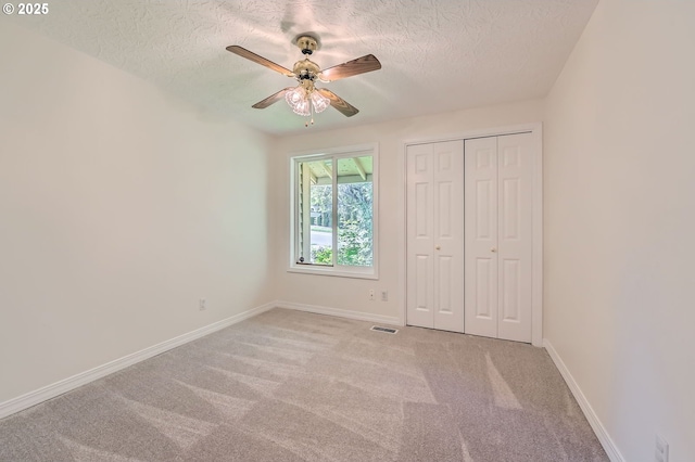 15911 NE 29th Ave, Ridgefield, WA 98642 - unfurnished bedroom with a textured ceiling, carpet floors, a closet, and a ceiling fan
