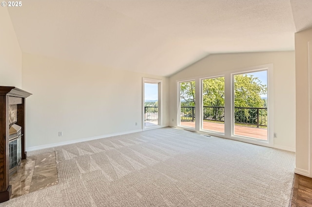 15911 NE 29th Ave, Ridgefield, WA 98642 - unfurnished living room featuring lofted ceiling, a tile fireplace, and carpet floors