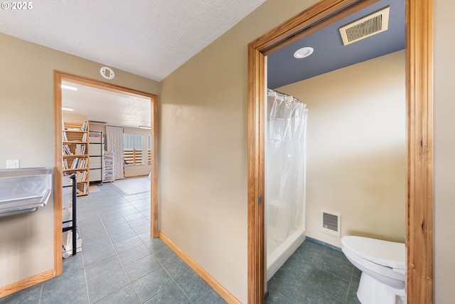 34700 Hill St, Pacific City, OR 97135 - bathroom with tile patterned floors, toilet, and curtained shower