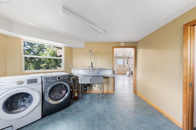 34700 Hill St, Pacific City, OR 97135 - laundry area with separate washer and dryer, a textured ceiling, baseboards, and dark tile patterned flooring