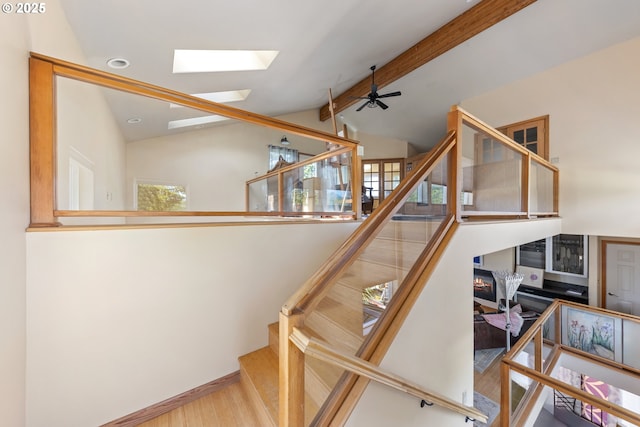34700 Hill St, Pacific City, OR 97135 - stairway with a skylight, wood finished floors, beamed ceiling, a ceiling fan, and high vaulted ceiling