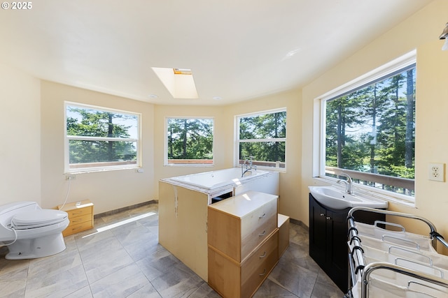 34700 Hill St, Pacific City, OR 97135 - bathroom featuring toilet, a skylight, a sink, and baseboards