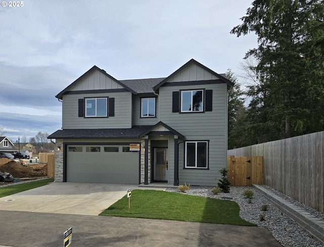 view of front facade featuring fence, roof with shingles, concrete driveway, a garage, and board and batten siding