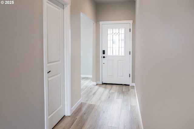 entryway with baseboards and light wood-style floors