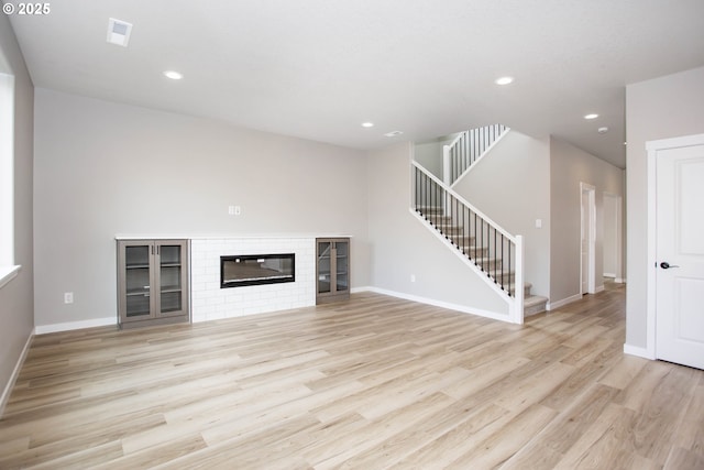 unfurnished living room featuring recessed lighting, stairway, visible vents, and light wood finished floors