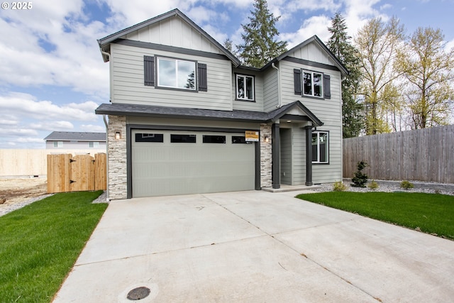 view of front facade featuring board and batten siding, an attached garage, stone siding, and fence