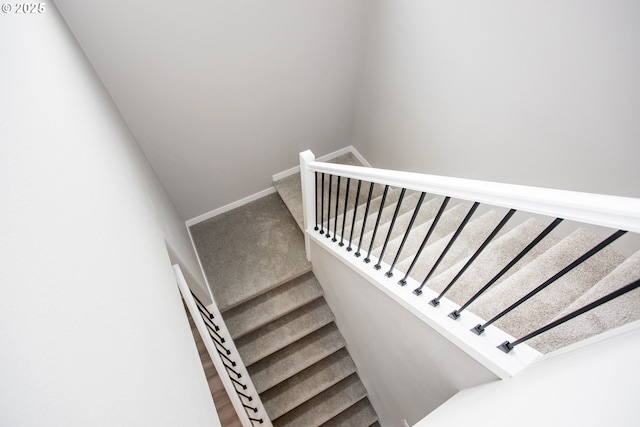 stairs featuring carpet and baseboards