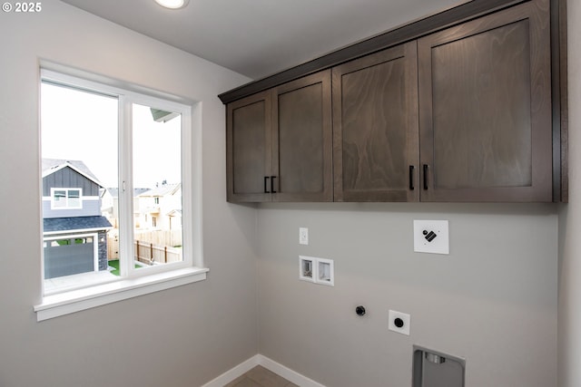 laundry room with cabinet space, washer hookup, baseboards, and hookup for an electric dryer