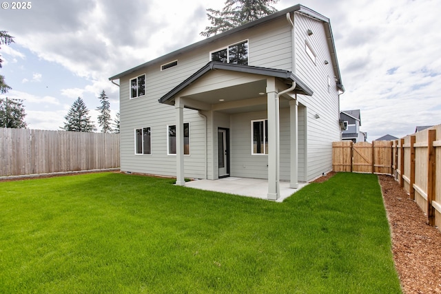 back of property featuring a lawn, a fenced backyard, and a patio