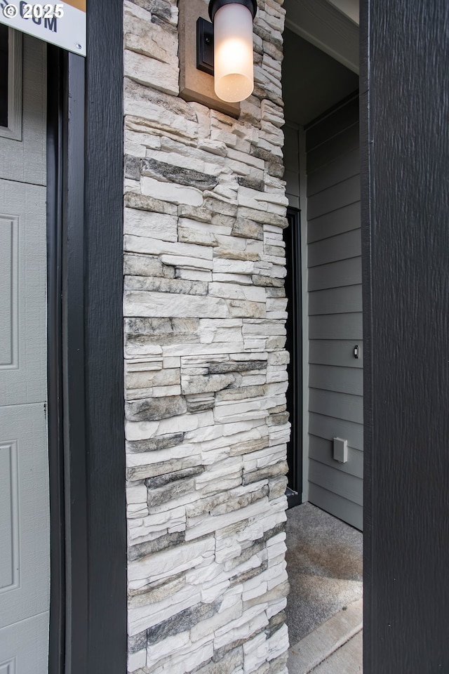 property entrance featuring stone siding