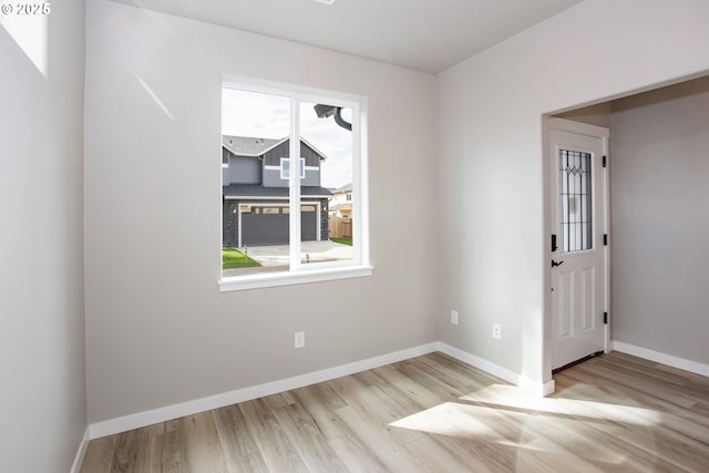 unfurnished room featuring wood finished floors and baseboards