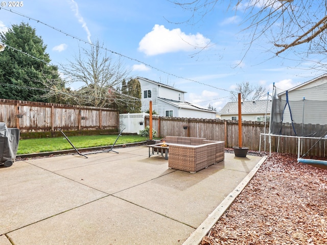 37388 SE Olson St, Sandy, OR 97055 - fenced backyard with a trampoline, a patio area, and an outdoor fire pit