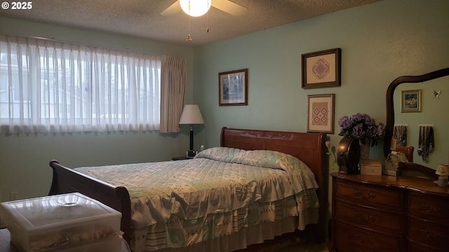 bedroom with ceiling fan and a textured ceiling