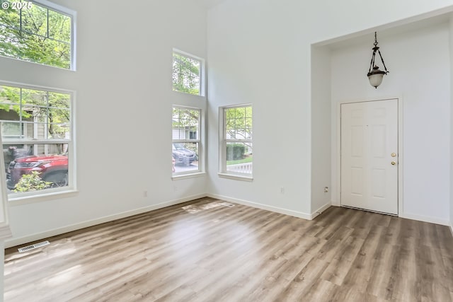 2370 NE 12th Way, Hillsboro, OR 97124 - foyer entrance with a high ceiling, light wood-style floors, and baseboards
