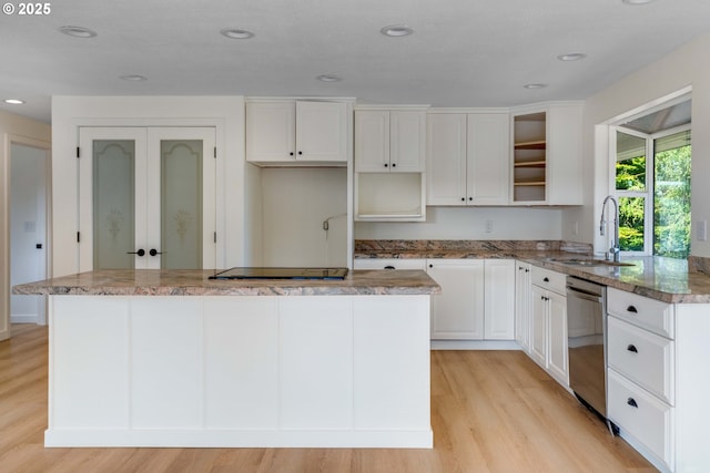 6195 Pear Tree Ln SE, Salem, OR 97317 - kitchen with dishwasher, a center island, light wood finished floors, white cabinetry, and stone countertops