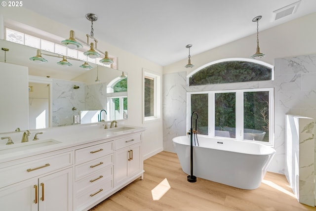 6195 Pear Tree Ln SE, Salem, OR 97317 - bathroom with a soaking tub, wood finished floors, double vanity, and a marble finish shower